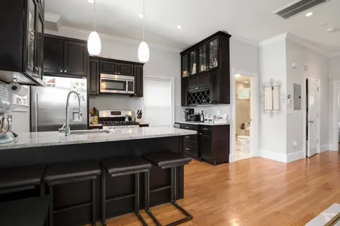 a kitchen with stainless steel appliances a sink stove and refrigerator