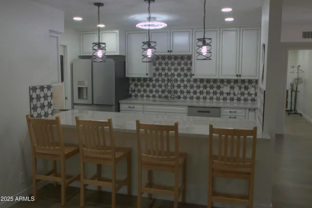 a view of a dining room with furniture and chandelier
