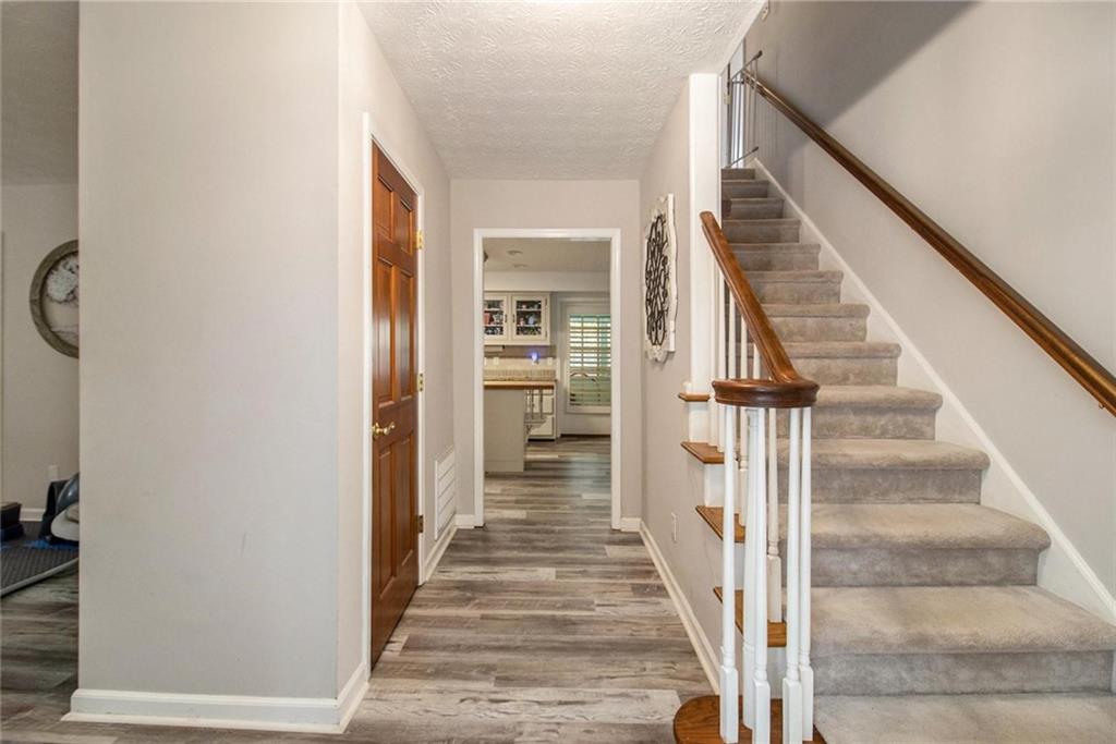 160 Old Field Road Sharpsburg, GA 30277 - Photo 15 of 58 a view of staircase with wooden floor and a potted plant