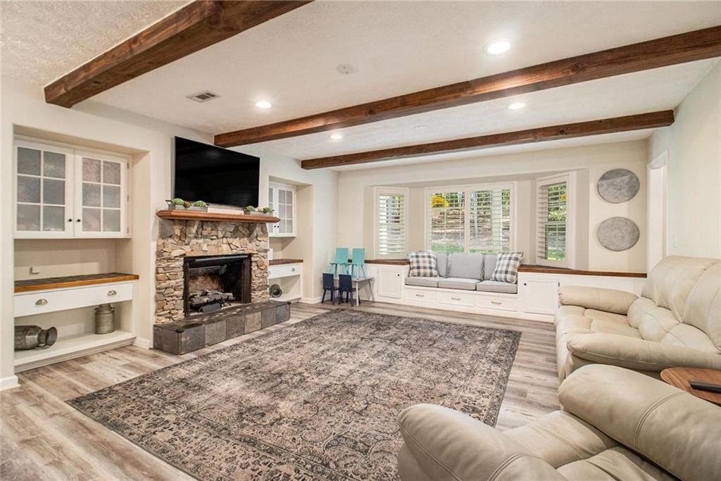 160 Old Field Road Sharpsburg, GA 30277 - Photo 18 of 58 a living room with furniture a flat screen tv and a fireplace