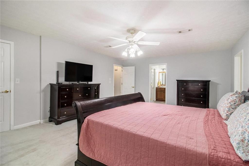 160 Old Field Road Sharpsburg, GA 30277 - Photo 29 of 58 a bed room with a bed a television and a fireplace