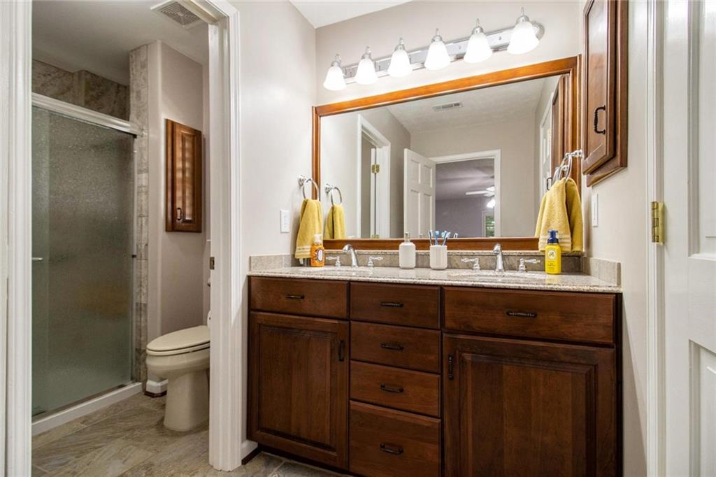 160 Old Field Road Sharpsburg, GA 30277 - Photo 30 of 58 a bathroom with a sink a toilet and a mirror