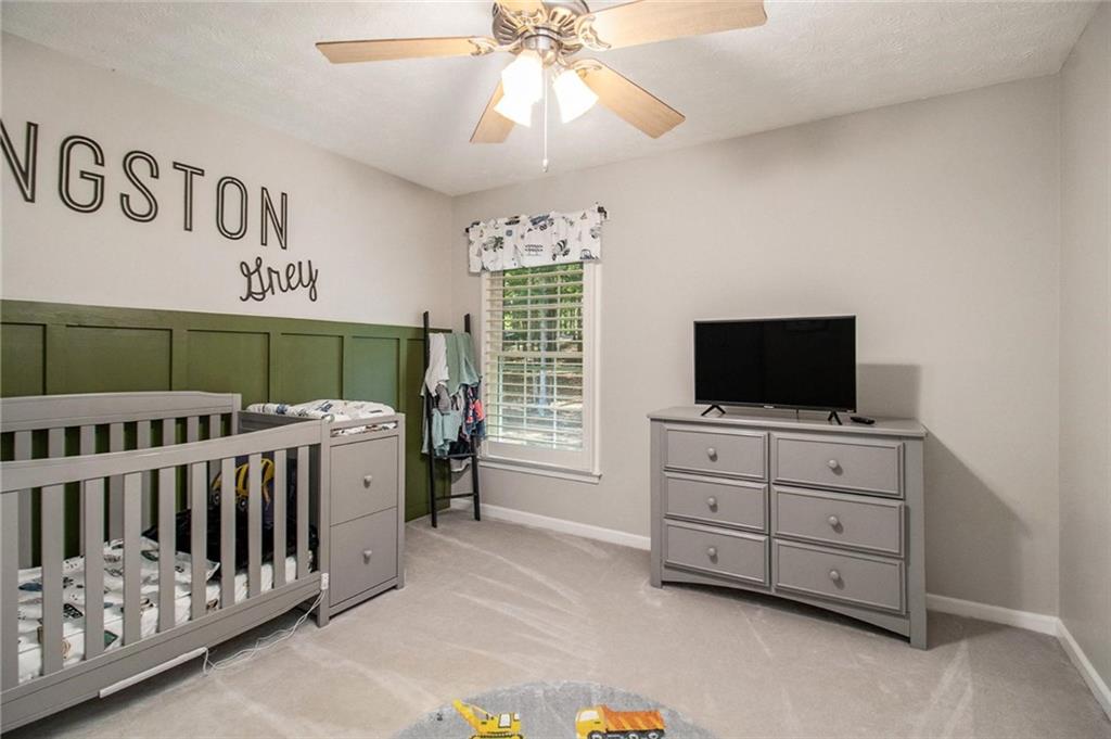 160 Old Field Road Sharpsburg, GA 30277 - Photo 35 of 58 a bedroom with furniture and a flat screen tv