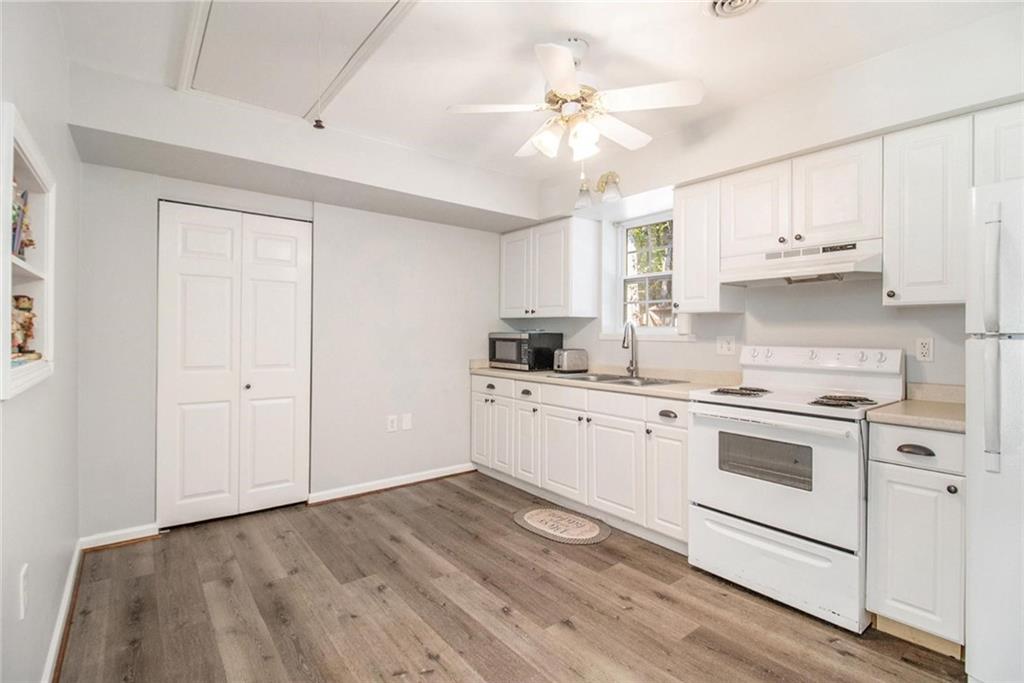 160 Old Field Road Sharpsburg, GA 30277 - Photo 48 of 58 a kitchen with cabinets wooden floor and a sink