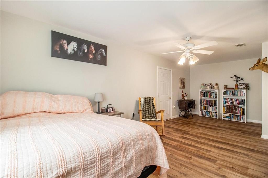 160 Old Field Road Sharpsburg, GA 30277 - Photo 49 of 58 a bedroom with a large bed and a chandelier