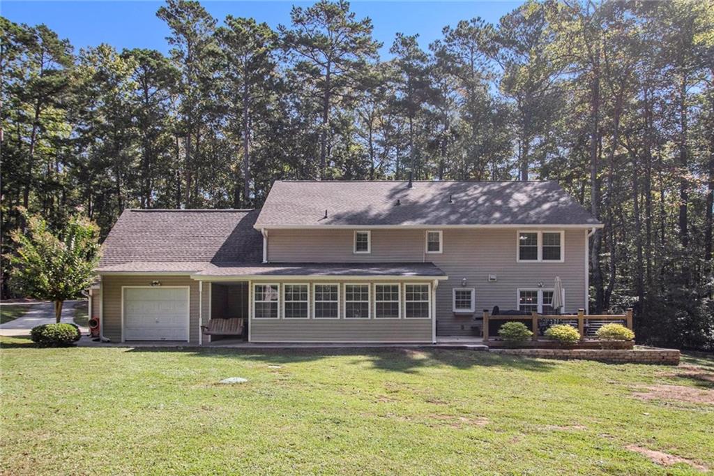 160 Old Field Road Sharpsburg, GA 30277 - Photo 7 of 58 a front view of a house with a yard table and chairs