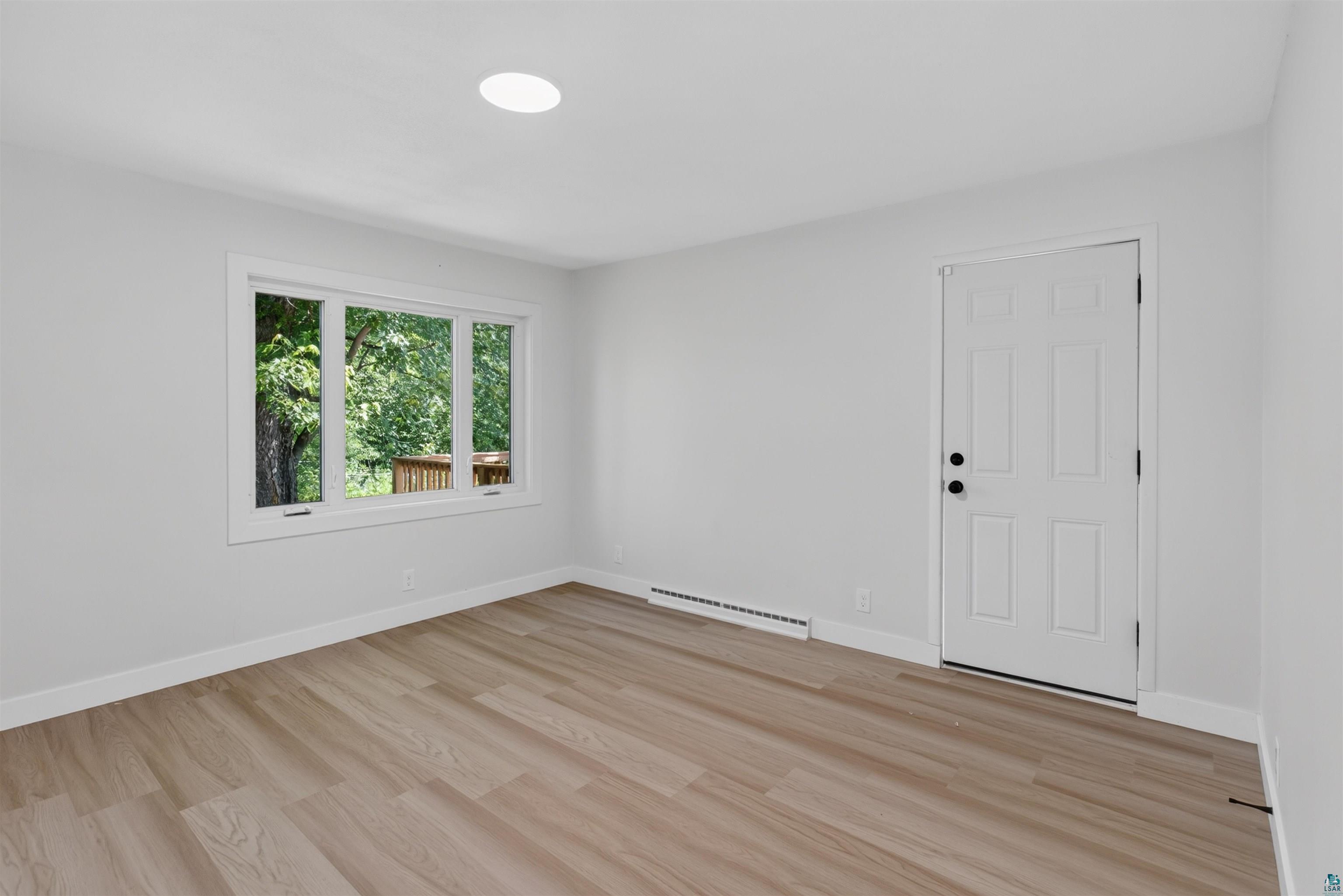 5868 Rice Lake Road Duluth, MN 55803 - Photo 17 of 39 Room featuring light wood-finish flooring, white walls, and a recessed ceiling light