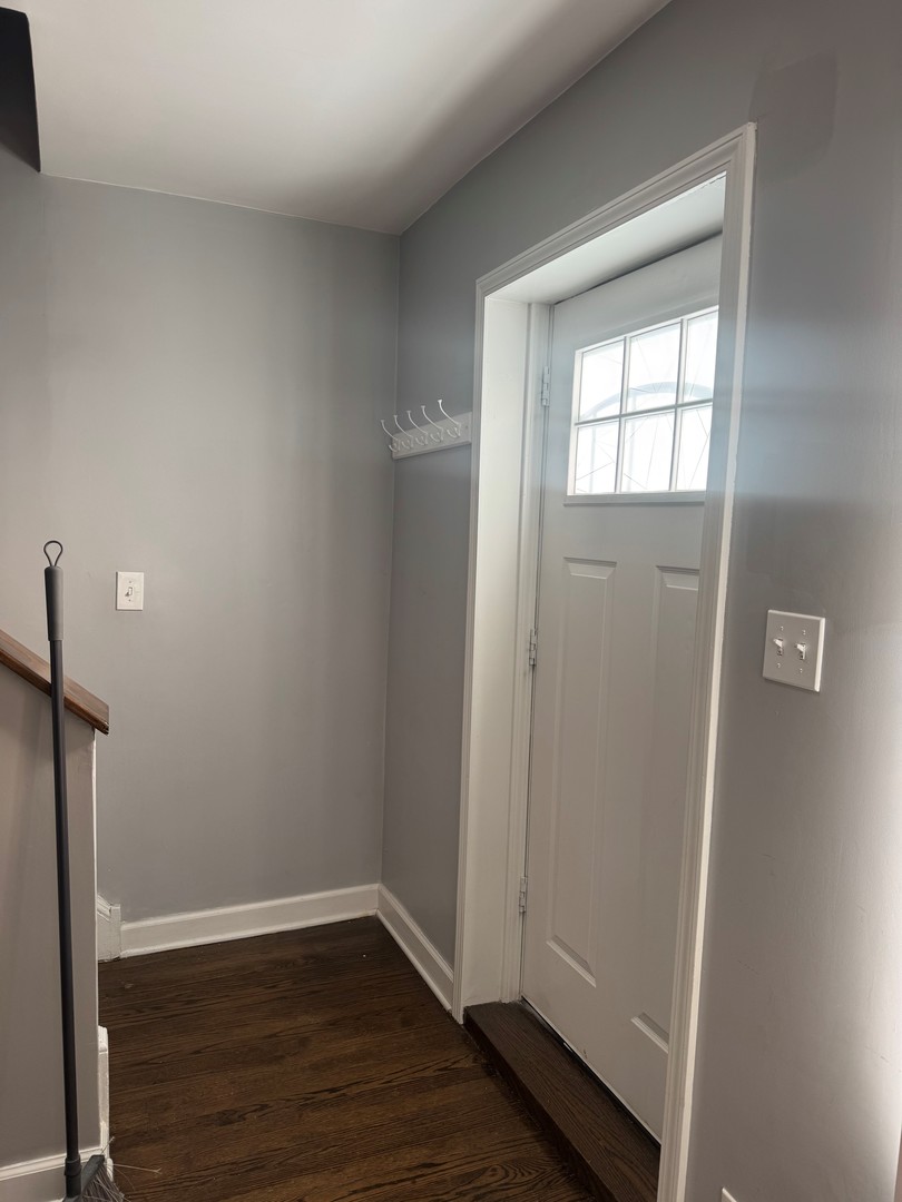 654 East 105th Street Chicago, IL 60628 - Photo 4 of 12 a view of an empty room with wooden floor and a window