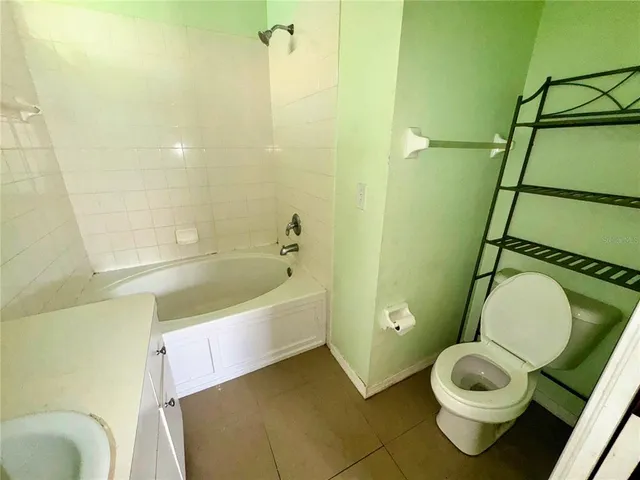 a bathroom with a toilet and a bathtub