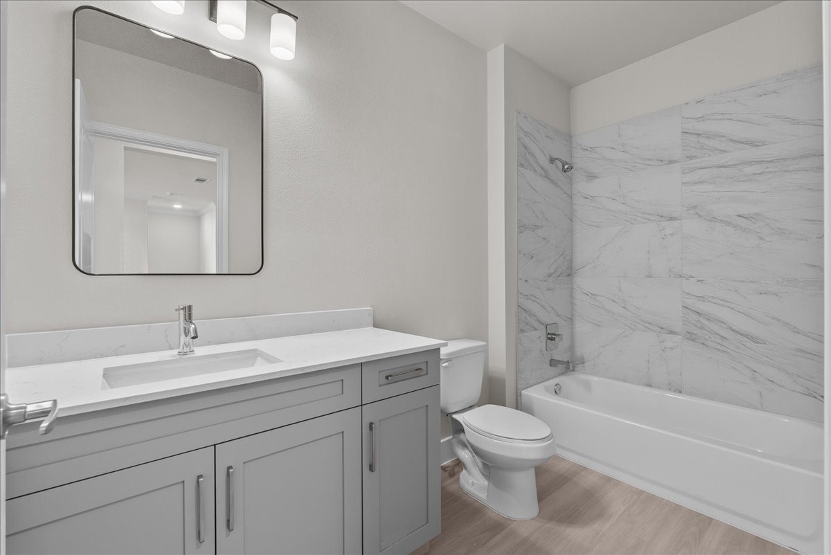 540 Hobbs Road, Unit E1 League City, TX 77573 - Photo 16 of 40 a bathroom with a toilet a sink a bathtub and a mirror