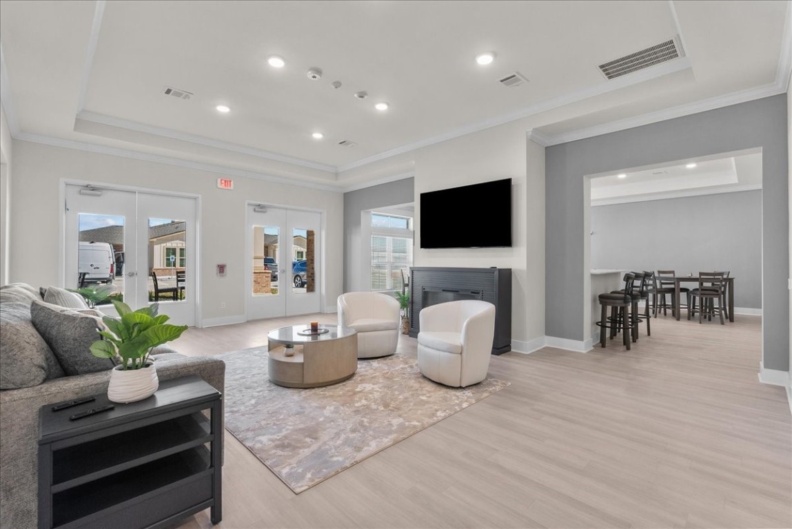 540 Hobbs Road, Unit E1 League City, TX 77573 - Photo 25 of 40 a living room with furniture a fireplace and a flat screen tv