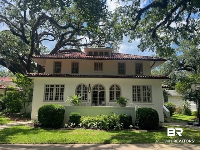 211 Lanier Avenue Mobile, AL 36607 - Photo 1 of 73 Rear view of house featuring a tile roof and stucco siding