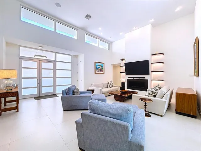 a spacious bathroom with a granite countertop double vanity sink a mirror and a bathtub