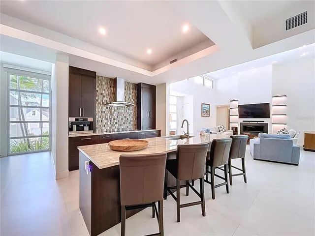 a large kitchen with a large window and stainless steel appliances