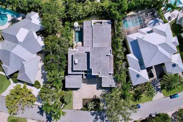 a view of a house with potted plants and a garage
