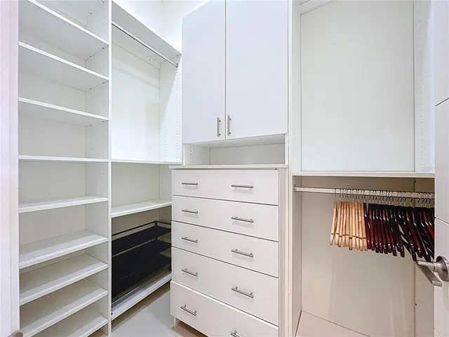 a view of a work space with furniture and floor to ceiling window