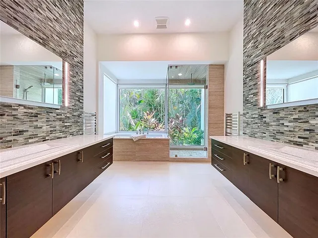 a front view of a house with a yard and potted plants