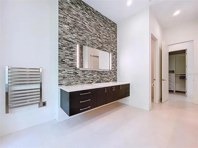 a front view of a house with a yard and a garden