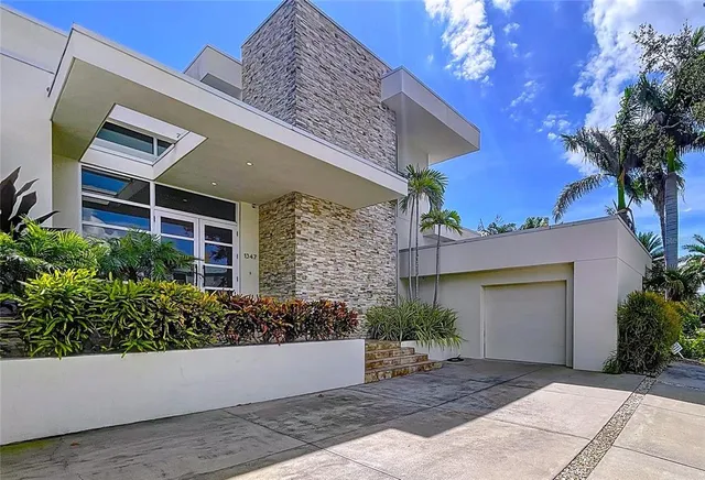 a living room with furniture a flat screen tv and a large window