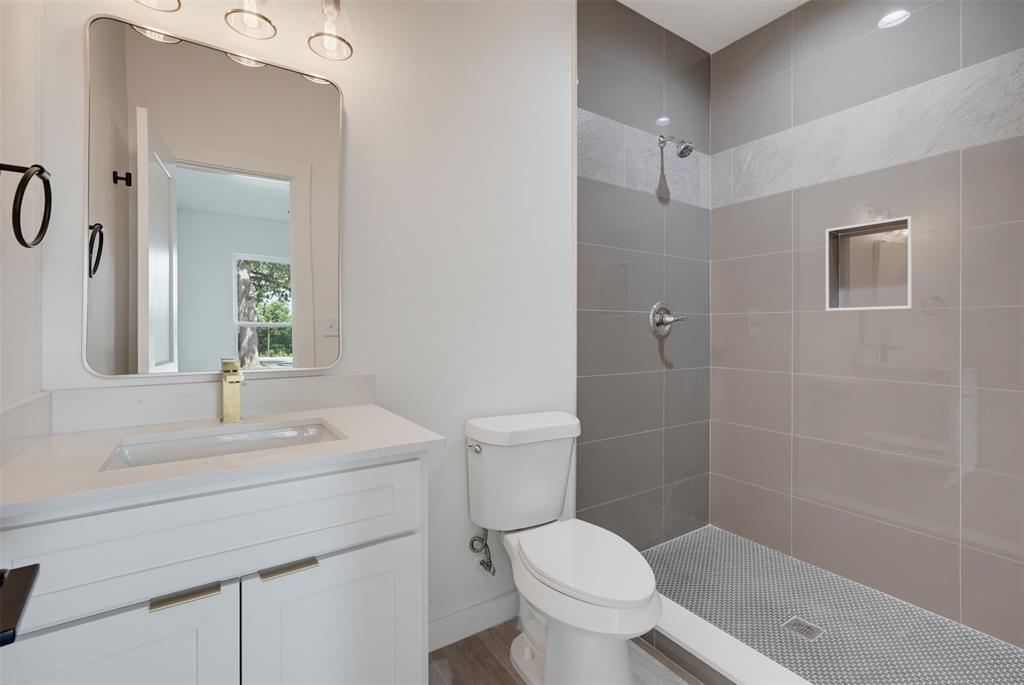 516 South O Connor Road Irving, TX 75060 - Photo 7 of 23 Bathroom featuring a white vanity with gold-finish hardware, a rectangular undermount sink, and a gold-finish faucet