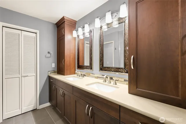 a bathroom with a double vanity sink mirror and double