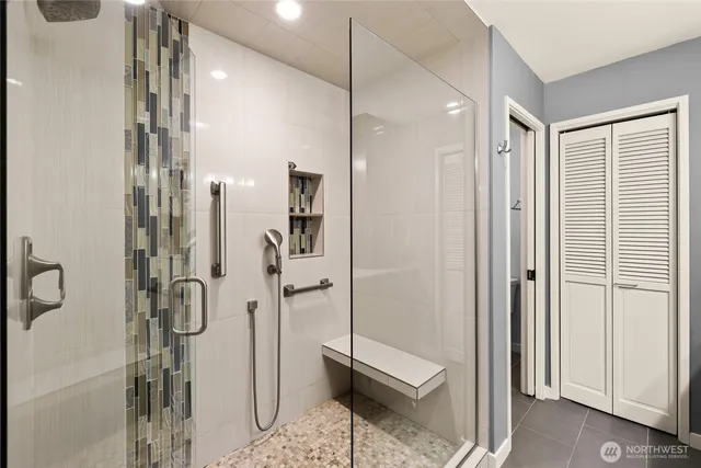 a bathroom with a shower and a glass door