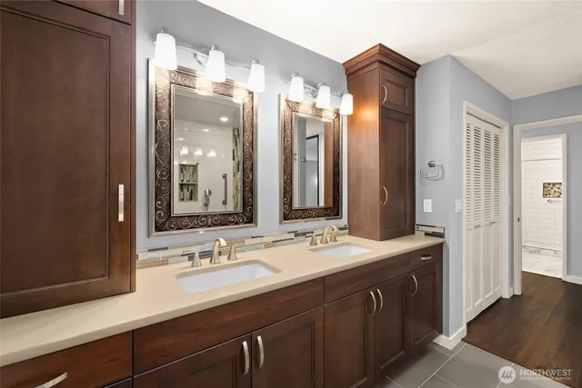 a bathroom with a double vanity sink and a mirror