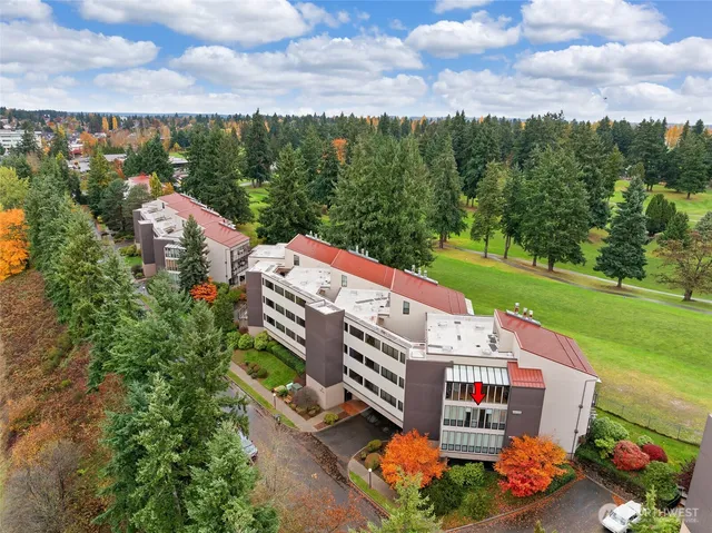 an aerial view of a house with a garden and lake view