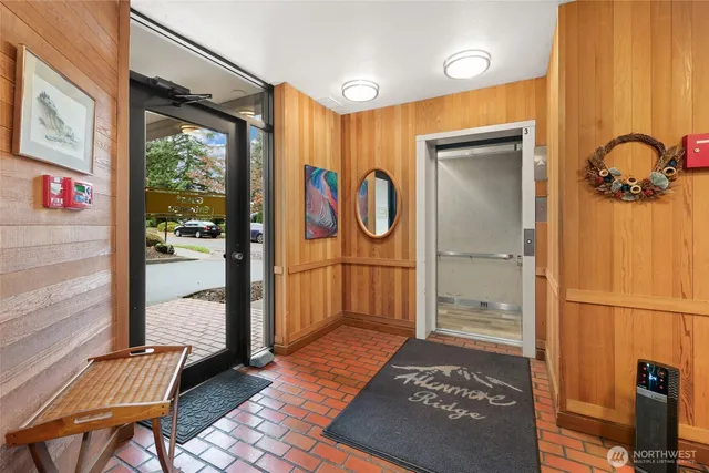 a view of a hallway with wooden floor and windows