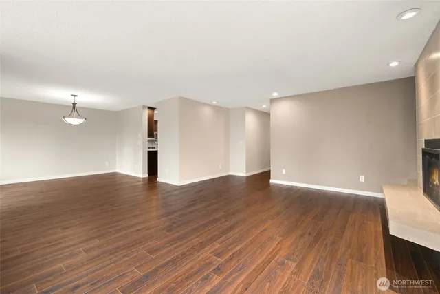 a view of empty room with wooden floor