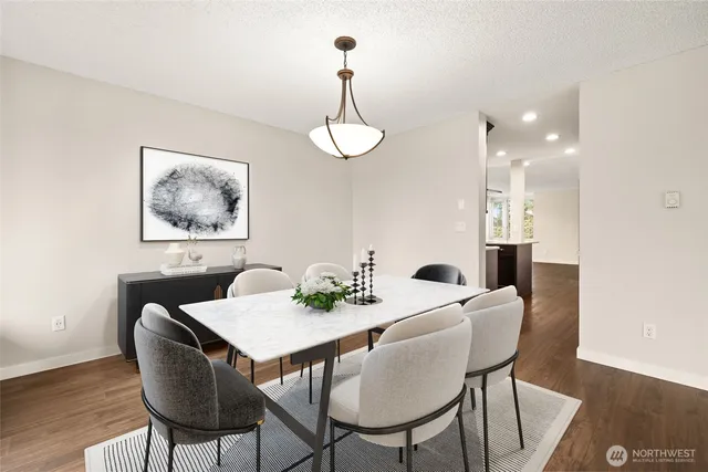a view of a dining room with furniture wooden floor and a chandelier