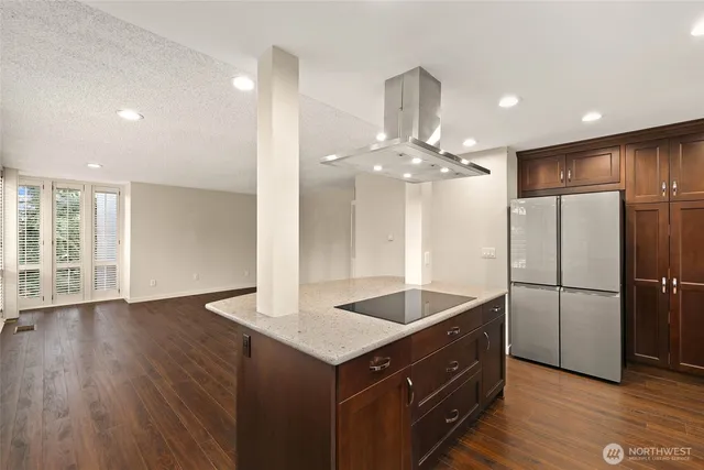 a kitchen with a refrigerator and countertop cabinets