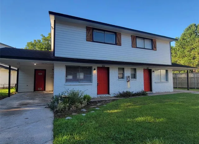 a view of entryway and kitchen with wooden floor