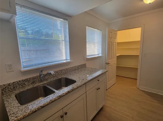 a bathroom with a granite countertop sink a toilet and a mirror