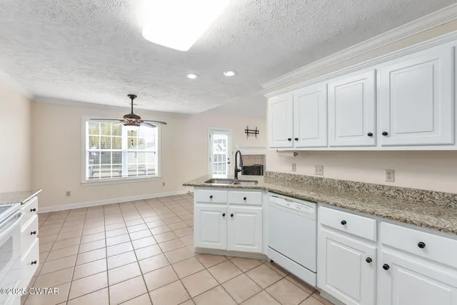 a kitchen with a sink window and cabinets