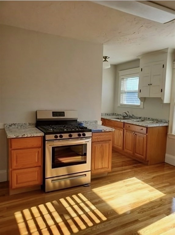 204 Eastern Avenue Lynn, MA 01902 - Photo 4 of 16 a kitchen with granite countertop a stove and a sink