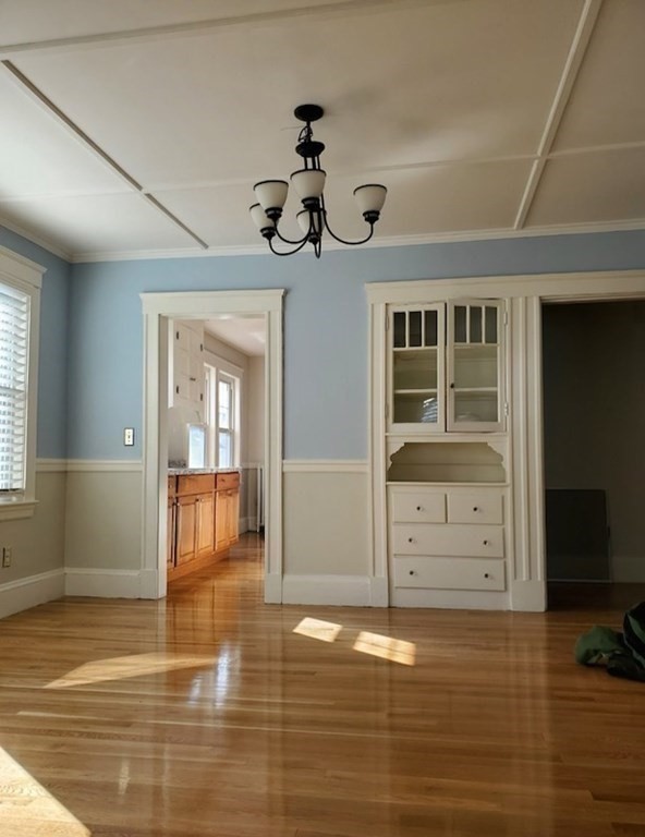 204 Eastern Avenue Lynn, MA 01902 - Photo 9 of 16 a view of an empty room with wooden floor and a window