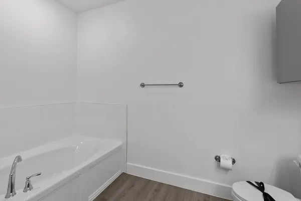 a bathroom with a double vanity sink mirror and toilet