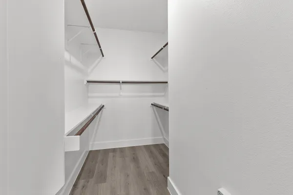 a view of a room with wooden floor