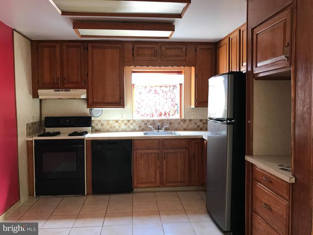 a kitchen with a refrigerator and a sink