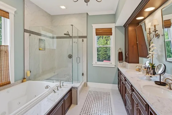 a bathroom with a granite countertop sink mirror and a bathtub