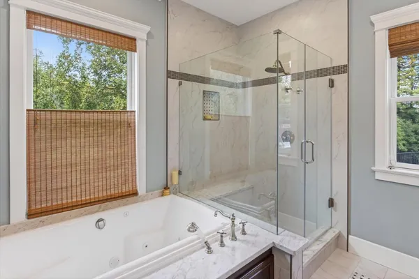 a bath room with a bath tub and a shower