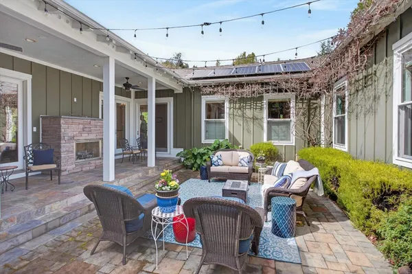 a view of a porch with furniture and a backyard