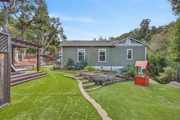 a front view of a house with a garden
