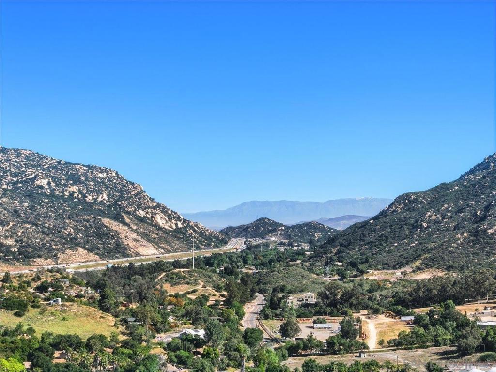 a view of a mountain range with lush green forest