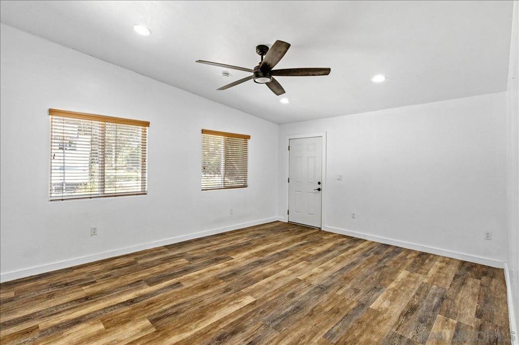 5461 Rainbow Creek Road Fallbrook, CA 92028 - Photo 15 of 28 a view of empty room with wooden floor and fan
