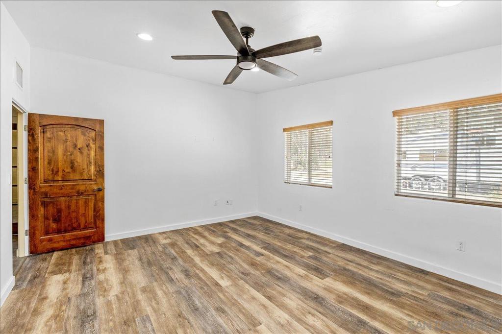5461 Rainbow Creek Road Fallbrook, CA 92028 - Photo 16 of 28 a view of empty room with wooden floor and fan