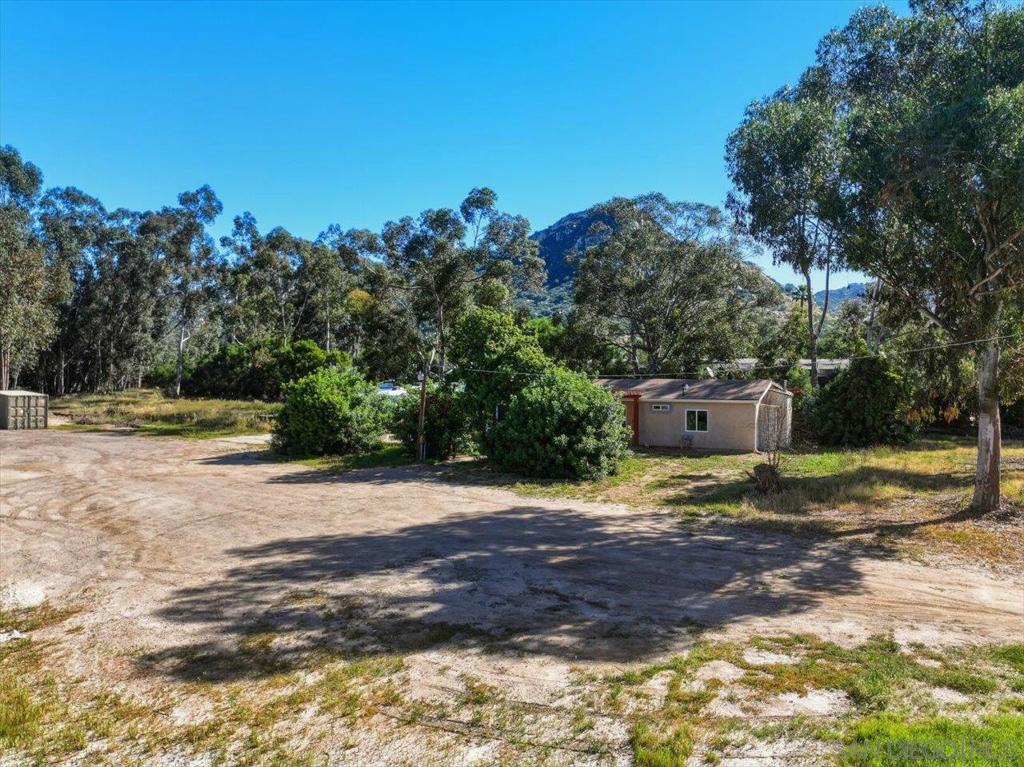 5461 Rainbow Creek Road Fallbrook, CA 92028 - Photo 5 of 28 a backyard of a house with table and chairs