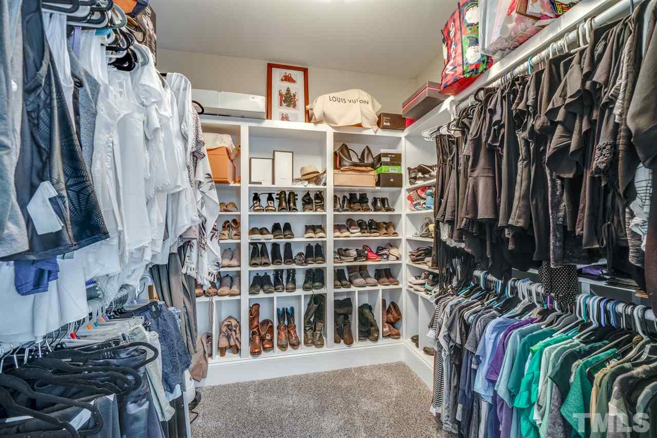 2256 Sanders Road Stem, NC 27581 - Photo 11 of 29 a view of walk in closet with clothes and shoes