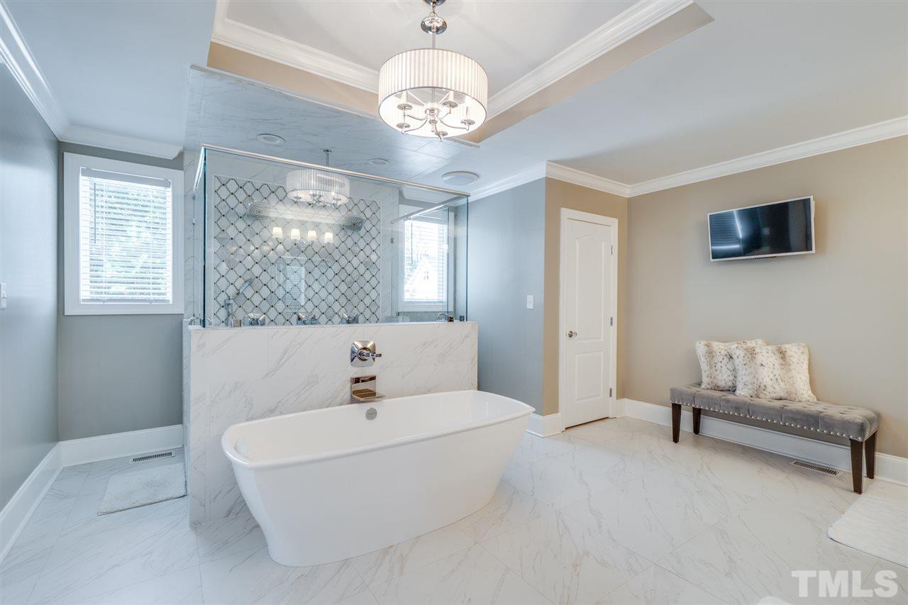 2256 Sanders Road Stem, NC 27581 - Photo 12 of 29 a bathroom with a white tub shower and fireplace